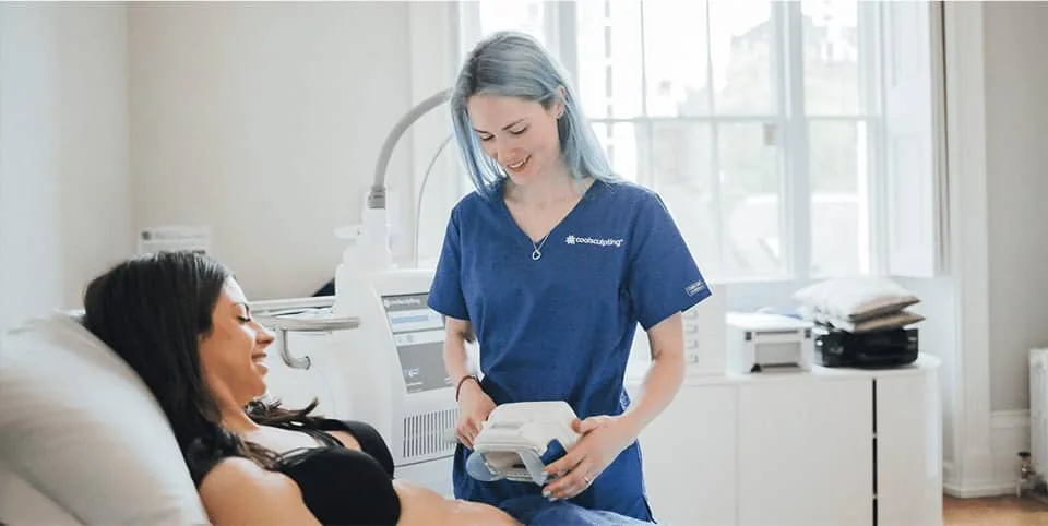 Nurse preparing a fat freezing device beside a patient on a couch at Cool Clinic, CoolSculpting fat freezing Dublin